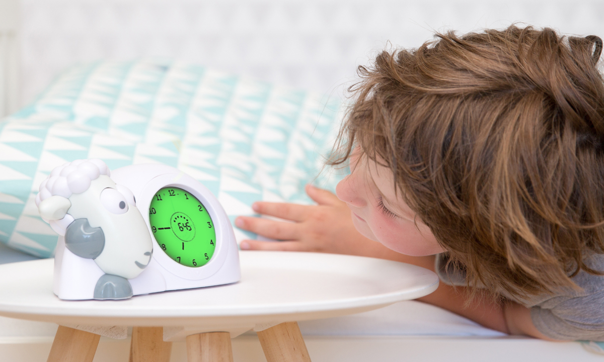 ZAZU Sam the Lamb sleep trainer glowing at bedtime